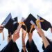 Group of students with graduation caps in the air